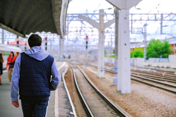 The window in the train. The platform of the station. People who walk on the platform of the station, blur. Blurred art Foundation.