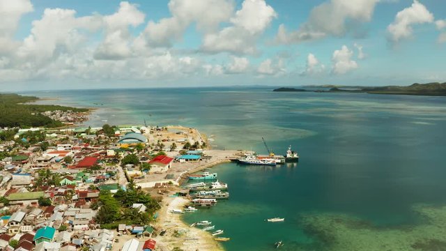 Passenger port with ferries and cargo ships on the island of Siargao,aerial view. Dapa Ferry Terminal. Siargao, Philippines.