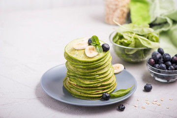 Stack of green spinach pancakes, healthy breakfast or snack, vegetarian food