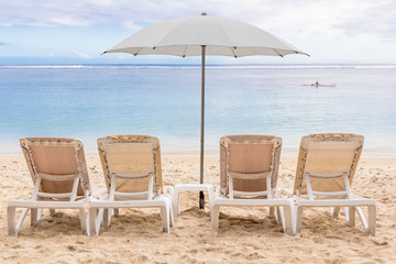 two chairs and umbrella on the beach