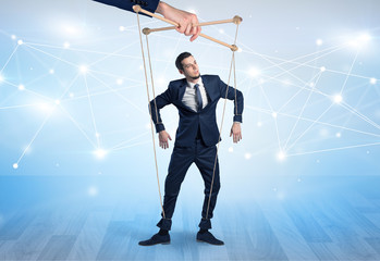 Puppet businessman controlled by another hand with financial concept