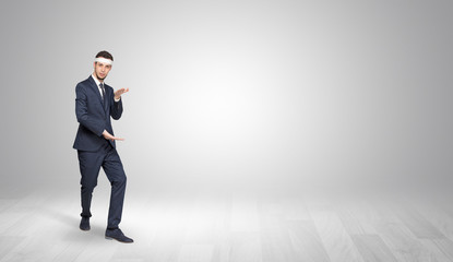 Young businessman in suit fighting in an empty space