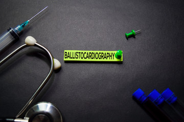Ballistocardiography text on Sticky Notes. Top view isolated on black background. Healthcare/Medical concept