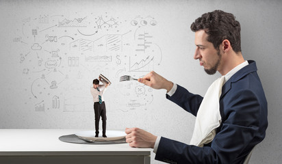 Big businessman eating small one with doodled reports, charts and graphs concept