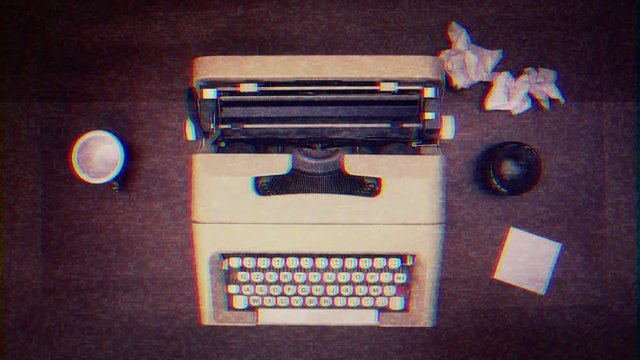 Intentional noise distortion fx tv transmission: an old vintage mechanical typewriter, surrounded by blank paper, a lens and an empty coffee cup. View from above.