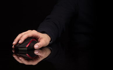 Hand using wireless mouse in a dark environment