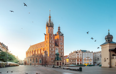 Naklejka na ściany i meble Mariacki Cathedral at Market square in Krakow at sunrise, Poland