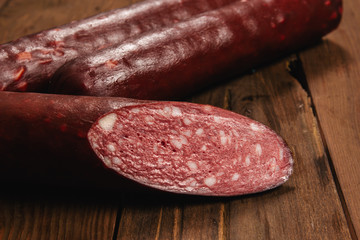 smoked sausage on wooden background