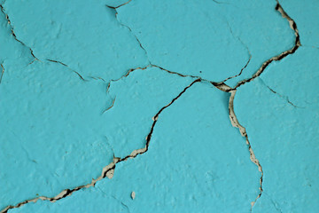 Obraz premium Wall with blue cracked paint close-up.