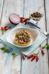 porridge with roasted sword fish capers and hot chili pepper