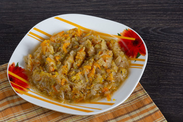 Stewed cabbage with carrot and onion on the plate