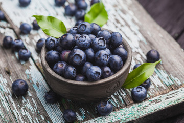 ripe blueberry berries on old wooden table. healthy food