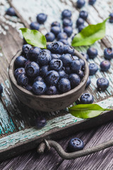 ripe blueberry berries on old wooden table. healthy food