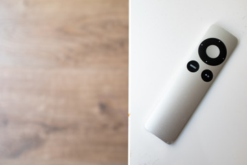 Metal remote control on a white table