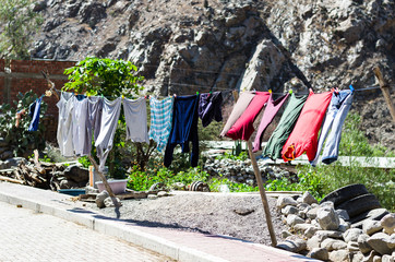 Rope with clean clothes outdoors on laundry day.
