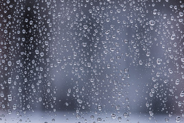 Naklejka na ściany i meble Water drops close up on a glass texture dark background