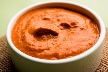 Peri Peri Sauce in a bowl, originally from portugal, it's a hot sauce made using piri piri or African bird's eye chillies.  selective focus