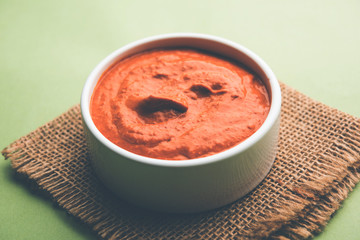 Peri Peri Sauce in a bowl, originally from portugal, it's a hot sauce made using piri piri or African bird's eye chillies.  selective focus