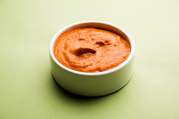 Peri Peri Sauce in a bowl, originally from portugal, it's a hot sauce made using piri piri or African bird's eye chillies.  selective focus