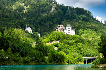 Castle Klaus on the blue lake in Austrian Alps. Summer day.