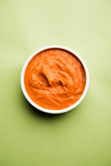 Peri Peri Sauce in a bowl, originally from portugal, it's a hot sauce made using piri piri or African bird's eye chillies.  selective focus