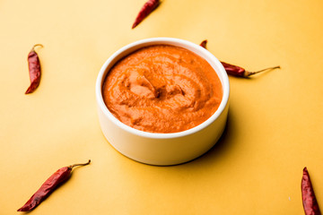 Peri Peri Sauce in a bowl, originally from portugal, it's a hot sauce made using piri piri or African bird's eye chillies.  selective focus