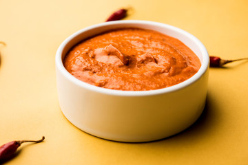 Peri Peri Sauce in a bowl, originally from portugal, it's a hot sauce made using piri piri or African bird's eye chillies.  selective focus