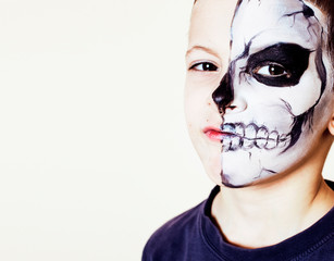 little cute boy with facepaint like skeleton to celebrate halloween, lifestyle people concept, children on holiday close up