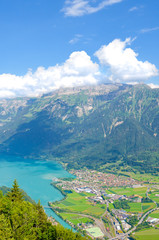Naklejka na ściany i meble Turquoise Lake Brienz in Interlaken, Switzerland from above from Harder Kulm. Beautiful Swiss landscapes. Green hills, Swiss Alps. Summer Alpine landscapes. Amazing view