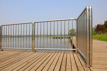 Naklejka premium Metal railings and planks in the park