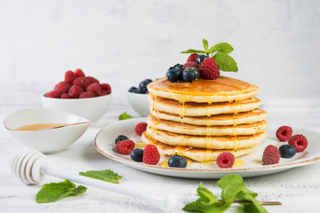 American pancakes with fresh berries and honey