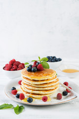 American pancakes with fresh berries and honey