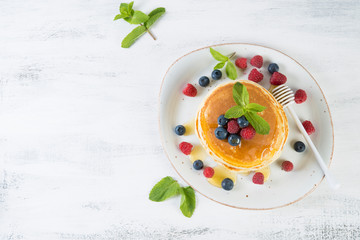 American pancakes with fresh berries and honey