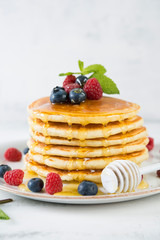 American pancakes with fresh berries and honey