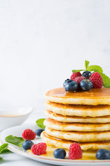 American pancakes with fresh berries and honey