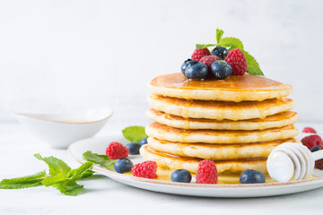 American pancakes with fresh berries and honey
