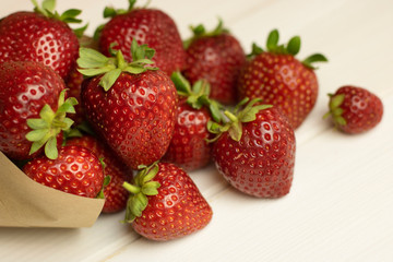 Fresh strawberry closeup on wooden background. Open space, healthy food concept, plants, soil, organic natural products, natural food, vegetarian dishes, vegetables, raw, food festival