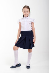  girl goes to first class .schoolgirl in school uniform on white isolated  background