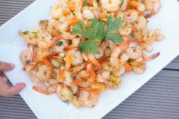 shrimps, children's hands take shrimps from the plate