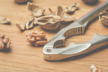 Walnut. A shell and nutcracker on a wooden table