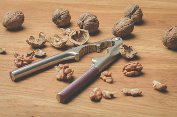 Walnut. A shell and nutcracker on a wooden table