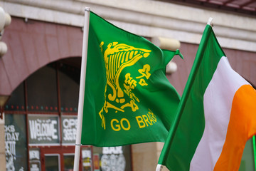 Waving Ireland flag on the street, St. Patrick's Day, closeup