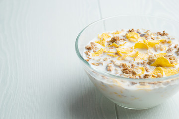 Glass bowl of cornflakes and milk