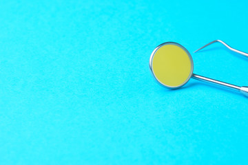 Dental tools on a blue background, a place for an inscription.