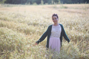 A young mother walk in wheat fields