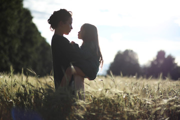 A young mother walk in wheat fields