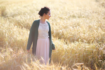 A young mother walk in wheat fields