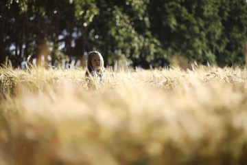 A young mother walk in wheat fields