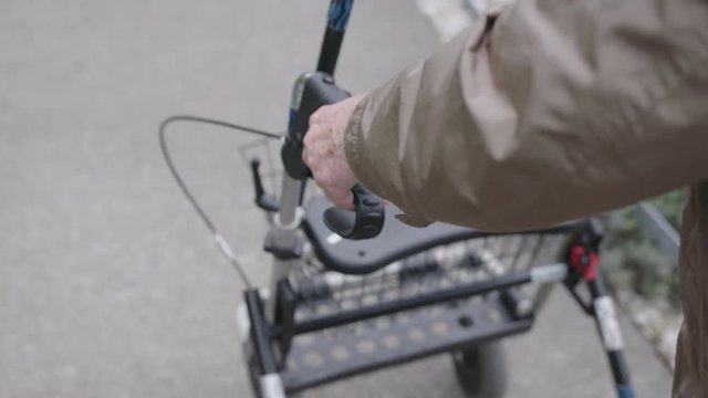 Elderly man pushing a rollator