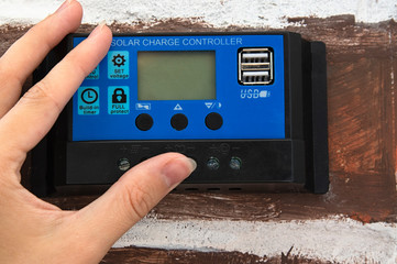 hands on solar charge controller © Nataliia Martynets
